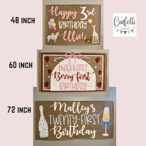 May include: Three brown paper banners with painted birthday messages. The top banner says "Happy 3rd Birthday Ellie!" with a zebra, giraffe, and monkey illustration. The middle banner says "Maci Kates Boory first Birthday" with pink and white lettering and strawberry illustrations. The bottom banner says "Malley's Twenty-First Birthday" with a champagne bottle and glass illustration.