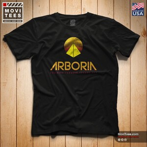 May include: Black t-shirt with a retro-style graphic of a pyramid with a sun setting behind it. The text "Arboria" is below the graphic, with the words "Serenity Through Technology" in smaller text below that.