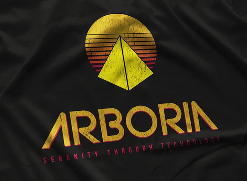 May include: A black t-shirt with a yellow and red retro-style logo that says "Arboria Serenity Through Technology". The logo features a yellow pyramid inside a red and yellow sun.