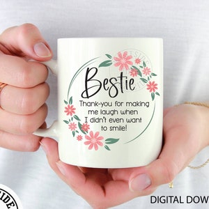 May include: White ceramic mug with a floral design and the text "Bestie Thank-you for making me laugh when I didn't even want to smile!"
