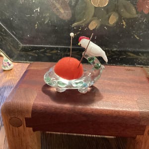 Vintage glass pincushion with white parrot perched on the tail of whale or a Axolotl, vintage figural glass pincushion, vintage pincushion