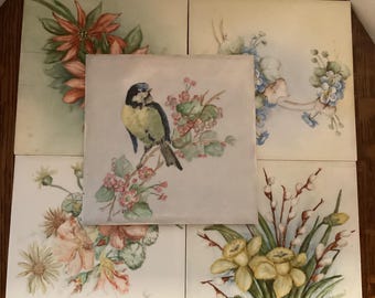 Five beautiful hand painted floral tiles including a tile with painted bird perched on a cherry blossom branch, daffodils, poinsettias