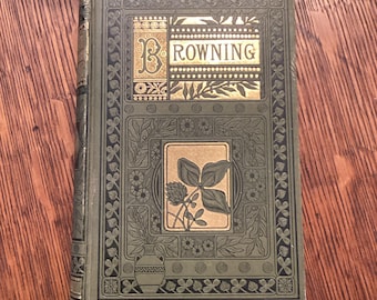 May include: A green book with gold lettering that reads "BROWNING" on the cover. The cover is decorated with a floral design and a shamrock.