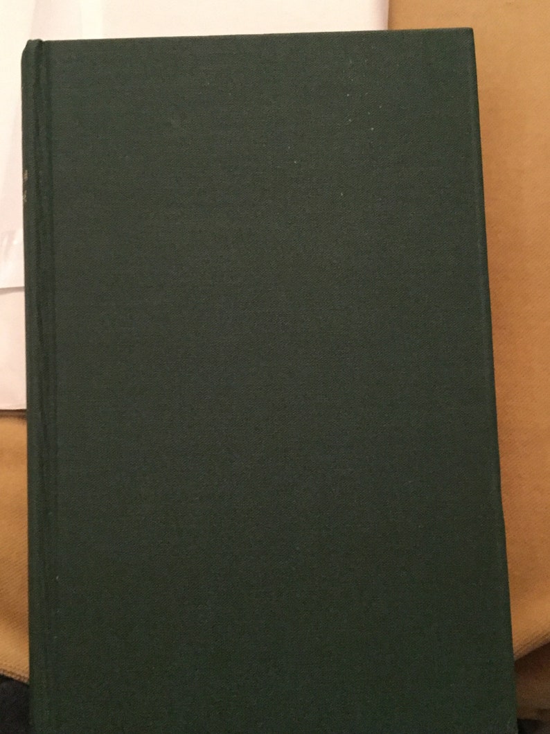 May include: A dark green hardcover book with a smooth, textured cover.