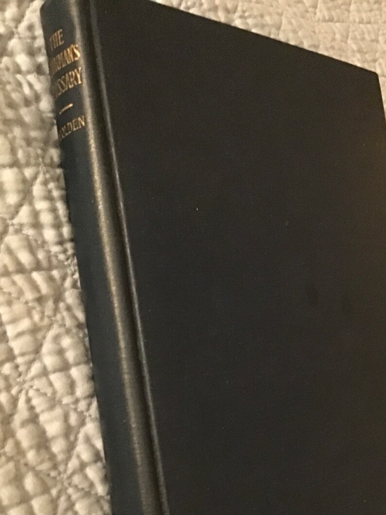 May include: A black leather-bound book with gold lettering on the spine that reads "The Merriam-Webster's Dictionary".