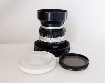 Nikkor-S Nippon Kogaku Japan Nikon 50mm f/1.4 non-AI manual focus lens with L39 52mm filter, 52mm polar filter and Nikon HS1 lens hood.