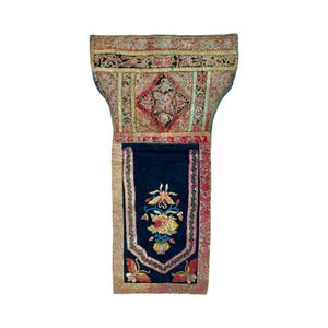 May include: A detailed antique textile, featuring a dark blue central panel and elaborate embroidery. The upper section displays a complex pattern in red, gold, and black. The lower panel has a floral design in yellow, pink, and blue, framed by a pink border.