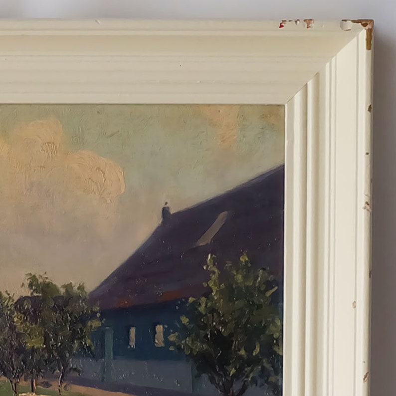 May include: A framed oil painting depicting a rural scene with a house, trees, and a cloudy sky. The house has a dark roof and a light blue exterior. The trees are green and the sky is a light blue with white clouds.