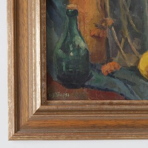 May include: A still life painting of a green glass bottle, a brown bottle, and a yellow fruit on a blue cloth. The painting is signed "G.J. Stulp '56" in the lower right corner.