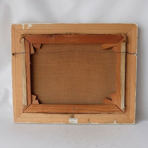 May include: The back of a framed painting with a wooden frame and a brown canvas. A label on the bottom right corner reads "3756".