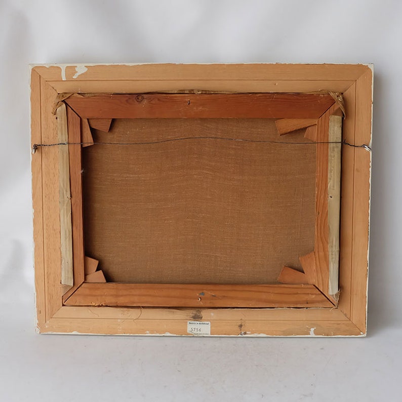 May include: The back of a framed painting with a wooden frame and a brown canvas. A label on the bottom right corner reads "3756".
