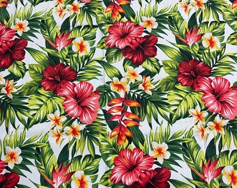May include: A white fabric with a tropical print featuring red hibiscus flowers, green leaves, and yellow flowers.