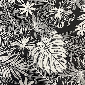 May include: Black and white tropical floral fabric featuring hibiscus flowers, monstera leaves, and other foliage. The design has a bold, graphic style with detailed white outlines against a solid black background. This fabric is suitable for apparel and home decor.