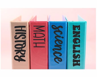 May include: Four three-ring binders in light pink, dark pink, blue, and teal. Each binder features black lettering on the spine reading HISTORY, MATH, SCIENCE, and ENGLISH respectively. The binders are arranged side-by-side in a vertical row.