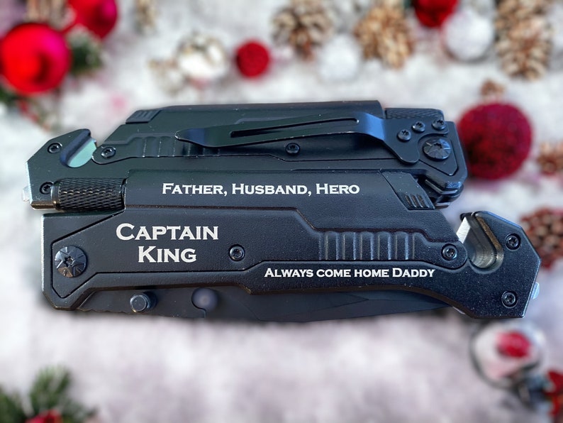 May include: Black multi-tool with a silver inscription that reads "Father, Husband, Hero, Captain King, Always Come Home Daddy".