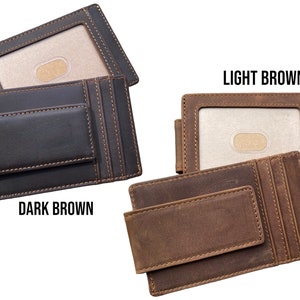 May include: Two leather wallets with a money clip. The wallet on the left is dark brown and the wallet on the right is light brown. Both wallets have a card slot and a money clip.