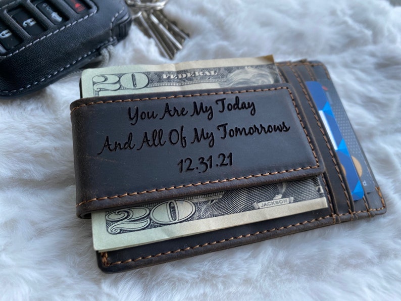 May include: A brown leather wallet with a money clip and a personalized inscription that reads "You Are My Today And All Of My Tomorrows 12.31.21".