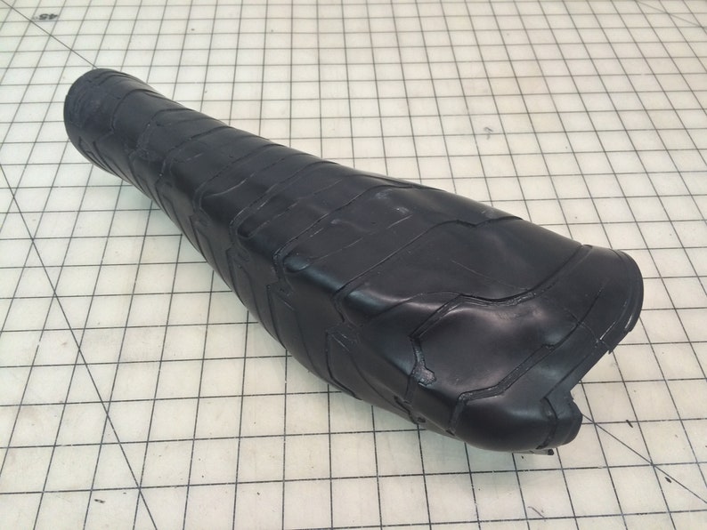 May include: Black leather motorcycle seat with a textured surface.