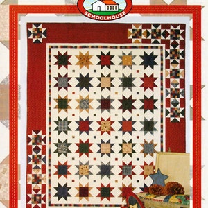 May include: A quilt pattern featuring a patchwork design of stars in red, blue, green, and cream colours. The pattern is called "Simply Scrappy Stars" and is from the Patchwork Schoolhouse 2016.