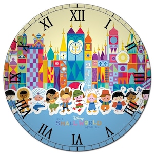 May include: A colorful clock face with a depiction of the 'it's a small world' ride at Disney World. The clock face features a whimsical castle with colorful buildings and characters from around the world. The clock face is surrounded by a blue background with the words 'it's a small world after all...' printed on it.