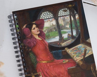 May include: A spiral bound notebook with a painting of a woman in a red dress sitting by a window. The woman is looking out the window and has her hands behind her head. The window is arched and has a view of a city and a bridge. The notebook has a black spiral binding.