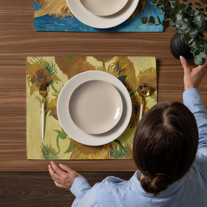 This stunning set of 4 placemats feature the infamous Sunflower paintings by Vincent Van Gogh. The most famous mostly yellow painting, and two with blue backgrounds. The contrasting yellows and blues will brighten up any table!