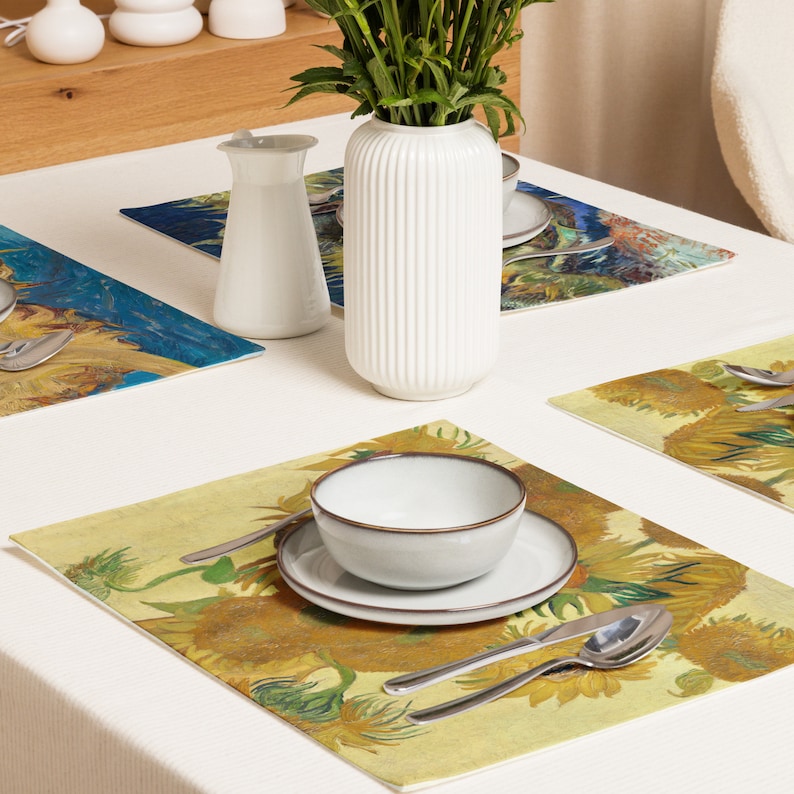 This stunning set of 4 placemats feature the infamous Sunflower paintings by Vincent Van Gogh. The most famous mostly yellow painting, and two with blue backgrounds. The contrasting yellows and blues will brighten up any table!