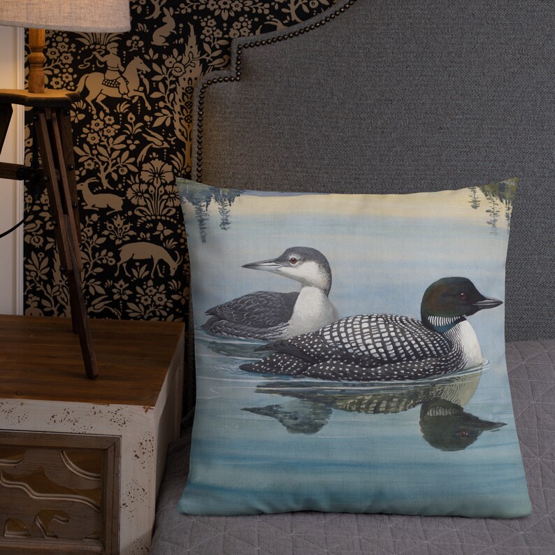 PrThis beautiful pillow comes in two sizes, 18x18 or 22x22 inch and features a painting of an adult and immature common loon. The amazing state bird of Minnesota! The perfect addition to any living room or cabin!emium Pillow