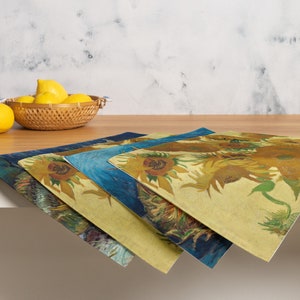 This stunning set of 4 placemats feature the infamous Sunflower paintings by Vincent Van Gogh. The most famous mostly yellow painting, and two with blue backgrounds. The contrasting yellows and blues will brighten up any table!