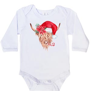 May include: White long-sleeved baby onesie featuring a watercolour illustration of a Highland cow wearing a Santa hat and holding a candy cane.
