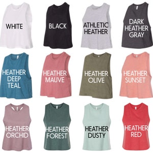 May include: Twelve sleeveless crop tops in various colors, including white, black, heather gray, heather deep teal, heather mauve, heather olive, heather sunset, heather orchid, heather forest, heather dusty, and heather red. Each top has a different color and is labeled with its color name.