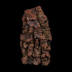 May include: A raw, naturally formed mineral specimen with a rugged, uneven surface. The object displays a deep, earthy reddish-brown coloration with dark, shadowed crevices and a dense, clustered crystalline structure throughout its entire form.