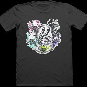 May include: A charcoal gray short-sleeve t-shirt featuring a graphic print of five Sanrio characters playing basketball. The center displays the San Antonio Spurs logo with the text 2026 NBA FINALS. Each character is surrounded by colorful paint splatters.