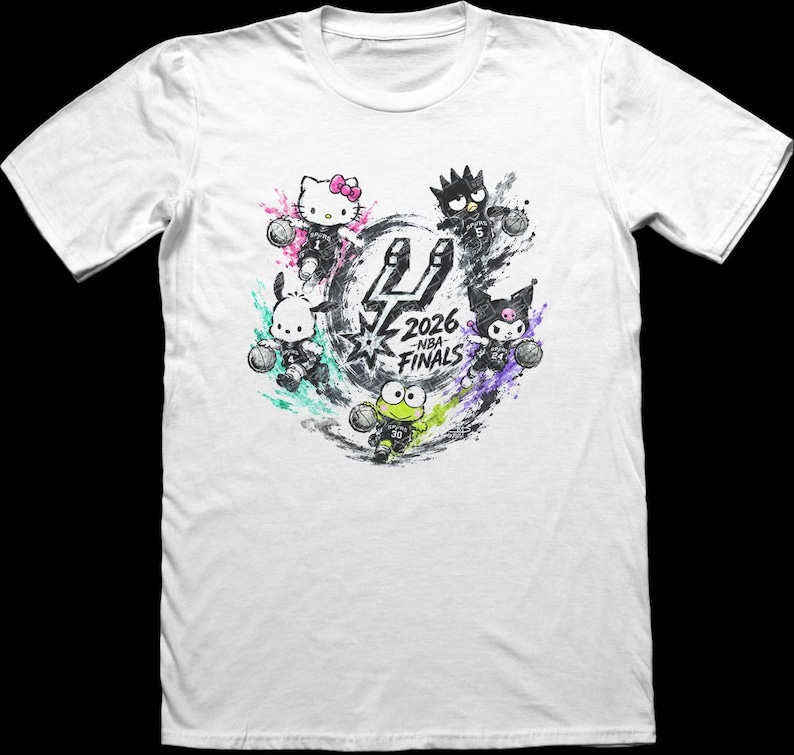 May include: A white short-sleeve t-shirt featuring a graphic of Sanrio characters playing basketball. The design includes the San Antonio Spurs logo and the text 2026 NBA FINALS, surrounded by colorful paint splatters and basketballs.