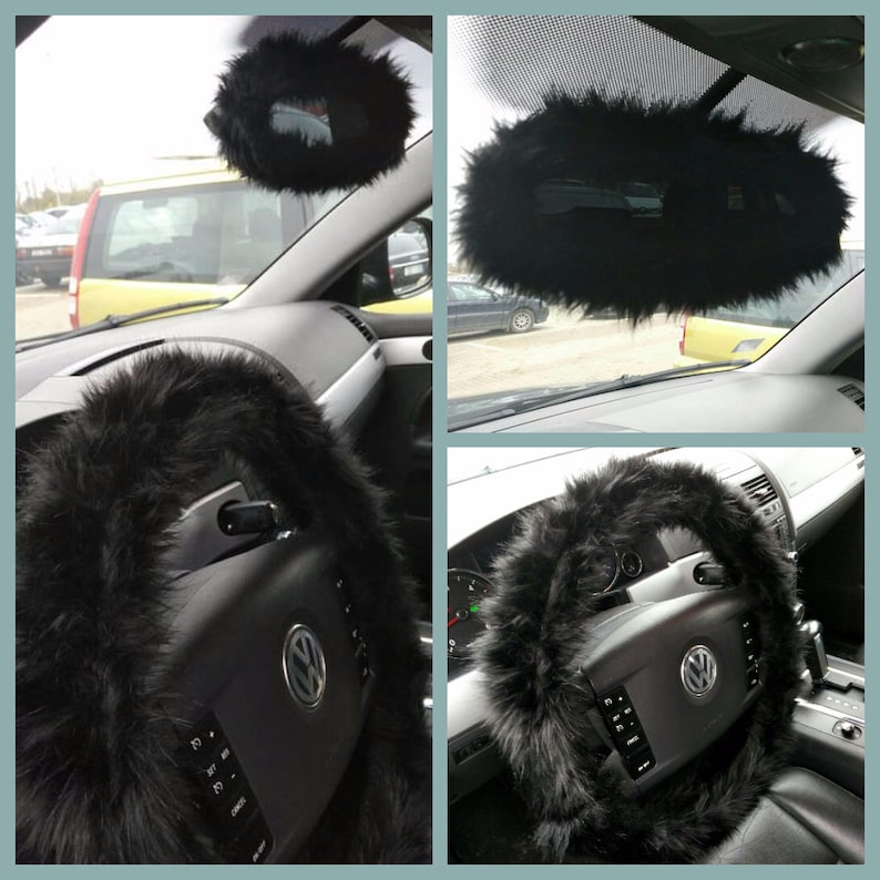 May include: Black faux fur steering wheel cover and rearview mirror cover for a car. The steering wheel cover is thick and fluffy. The rearview mirror cover is round and has a fluffy texture.