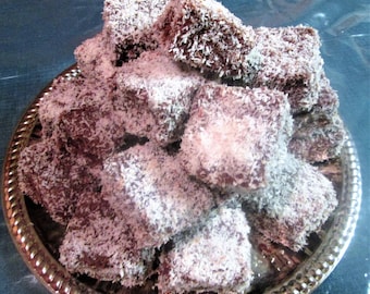 Lamingtons. Sponge Cake covered in Chocolate, and rolled in Dessicated Coconut. Favorite Dessert of our Aussie friends. 1 doz per order