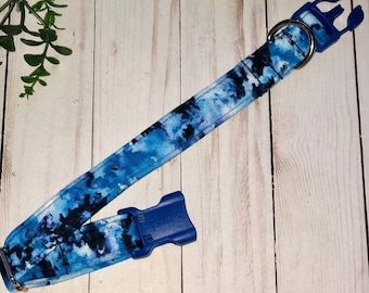 May include: A blue and black tie-dye dog collar with a blue plastic buckle.