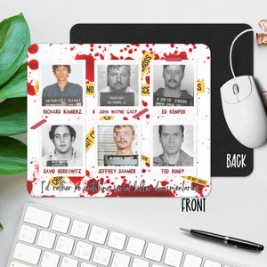 May include: A white mousepad with red blood splatter and yellow crime scene tape. The mousepad features mugshots of six serial killers: Richard Ramirez, John Wayne Gacy, Ed Kemper, David Berkowitz, Jeffrey Dahmer, and Ted Bundy. The text "I'd rather be watching serial killer documentaries" is printed on the mousepad.