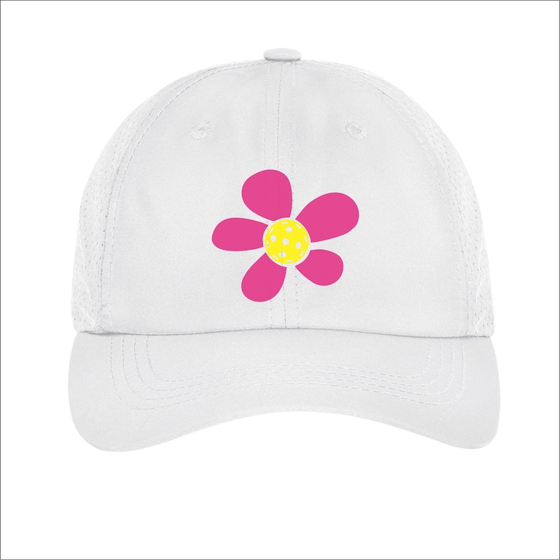 May include: White mesh baseball cap with a pink flower design. The flower has a yellow center with white polka dots.