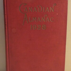 May include: A red hardcover book with the title "CANADIAN ALMANAC 1928" in gold lettering.