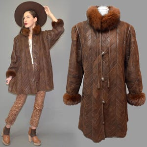 May include: A white ceramic mug with a black handle and the text "But First, Coffee" in a black, bold font. The mug is on a white surface.