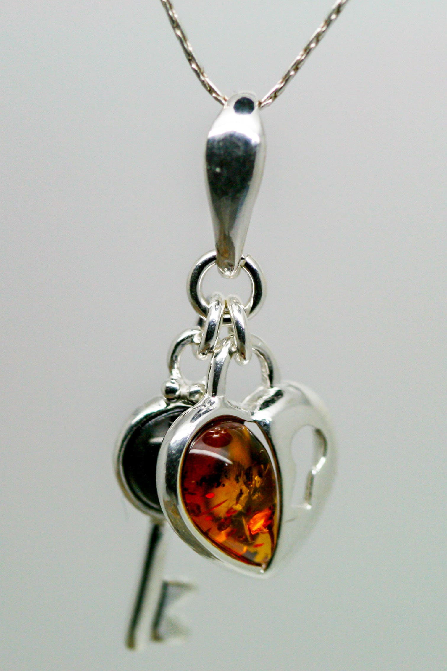 Heart shaped pendant. Whitby Jet and Amber pendant. Sterling Silver