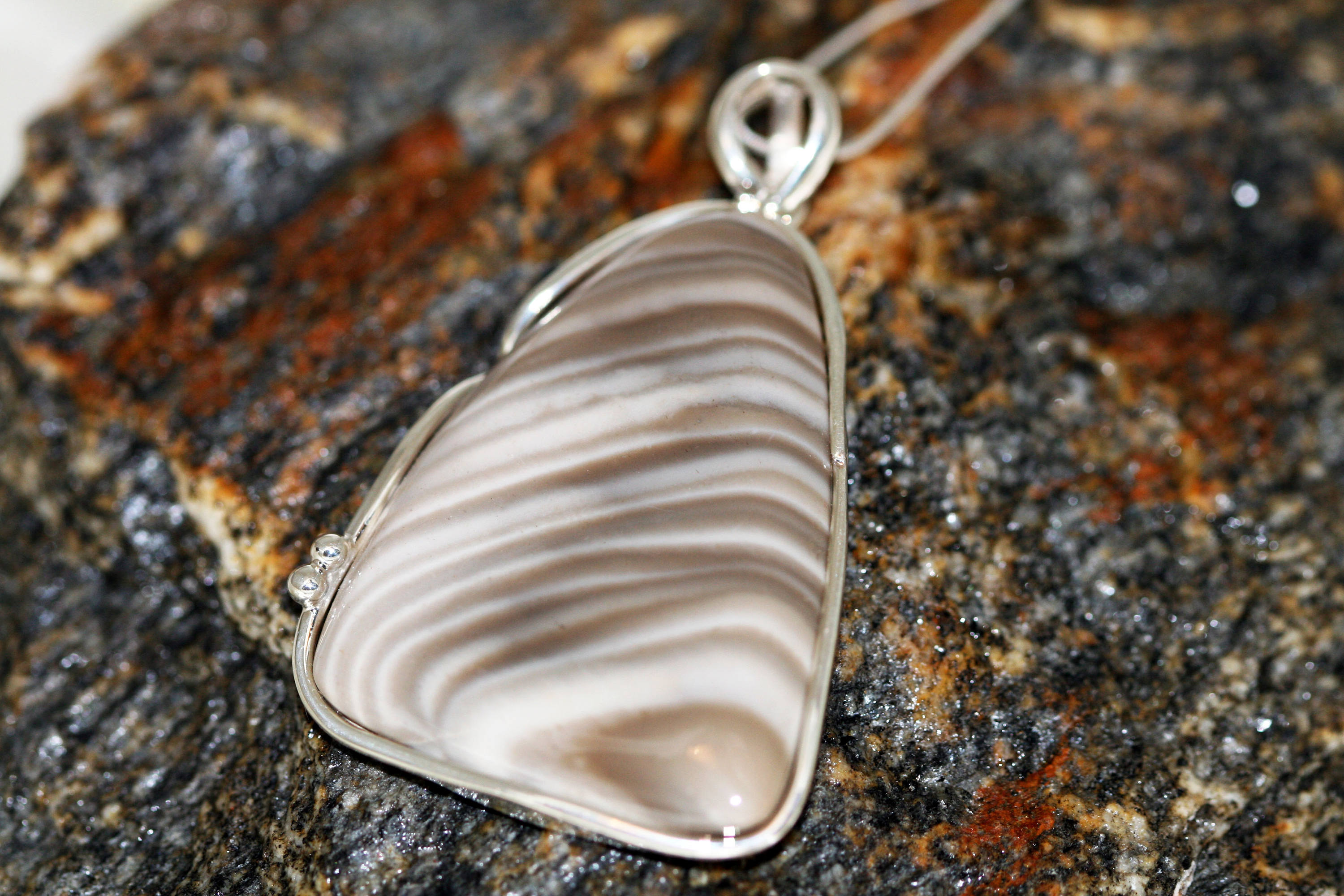 Striped Flint pendant fitted in sterling silver setting.