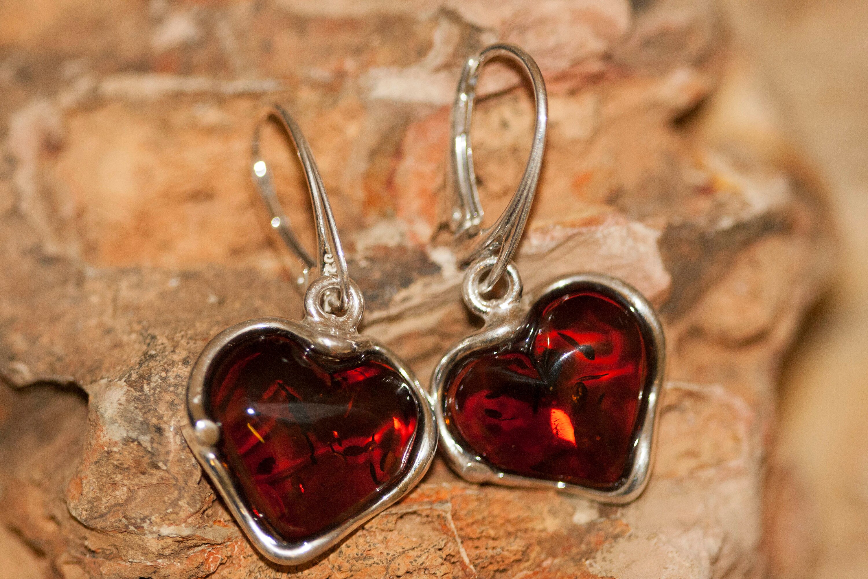 Heart shaped amber earrings fitted in a Sterling Silver setting