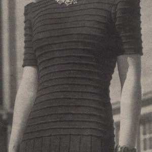 May include: A black and white striped knit dress with a scoop neck and short sleeves.