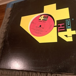 May include: A black vinyl record with a yellow and red label. The label features the text "4TH BWAY" and "MOBB DEEP". The record title is "Ht From The Back (Clean Version)".