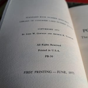May include: Open book page with text. Copyright 1971 by John W. Gofman and Arthur R. Tamplin. Text includes "All Rights Reserved" and "Printed in U.S.A." The book is a first printing from June 1971.