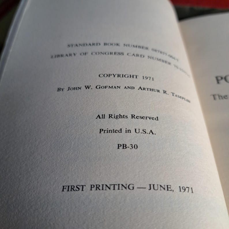 May include: Open book page with text. Copyright 1971 by John W. Gofman and Arthur R. Tamplin. Text includes "All Rights Reserved" and "Printed in U.S.A." The book is a first printing from June 1971.