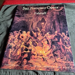 May include: A San Francisco Opera program for the Fall Season 1989 production of Falstaff. The cover features a detailed, colorful illustration of a theatrical scene with numerous figures in period costumes. The publication is from the Performing Arts Network.