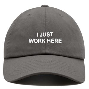 May include: A gray baseball cap with white embroidery that reads "I JUST WORK HERE".